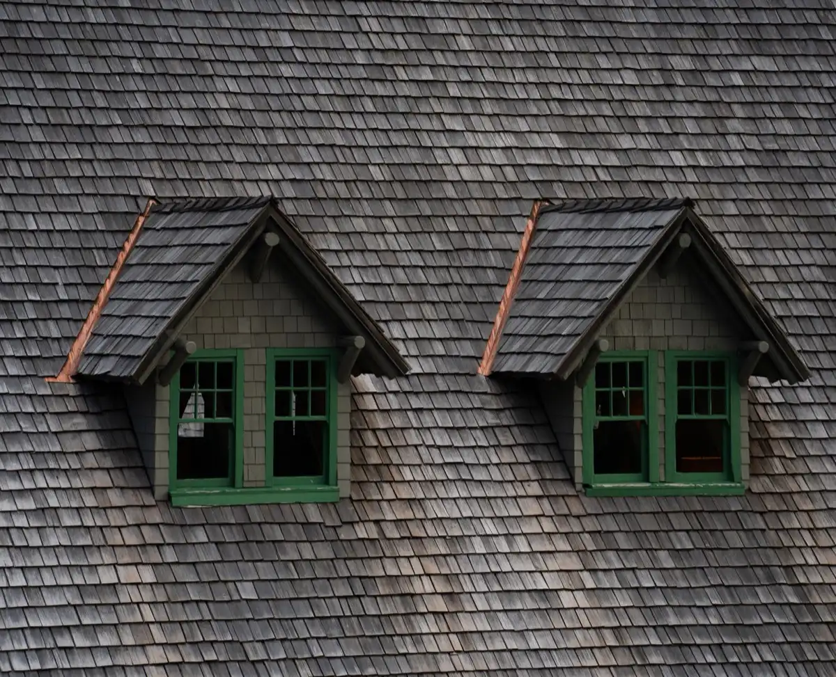 Dormers on a shingle roof in Decatur, IL, where step flashing and kickout flashing carry water past the walls